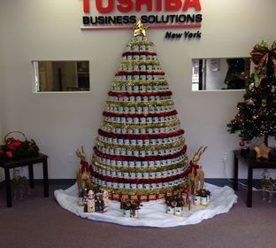 Canned goods stacked to resemble a Christmas tree were donated by TBS employees, and then given to a local food shelter.